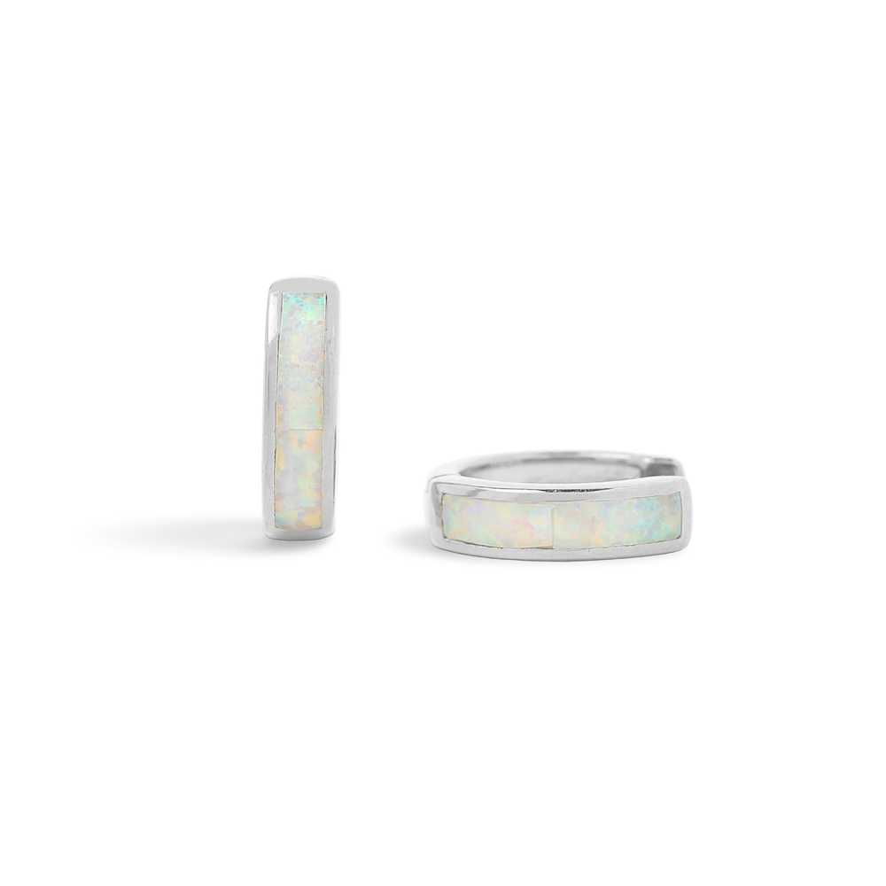 A pair of huggie hoop earrings with opal inlay, available in 18K gold over sterling silver or pure sterling silver.