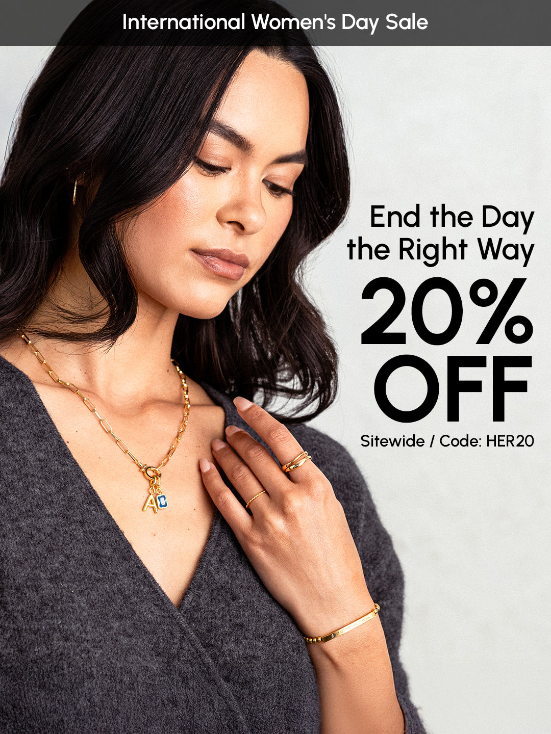 Woman wearing gold jewelry with promotional text for International Women's Day Sale on a gray background
