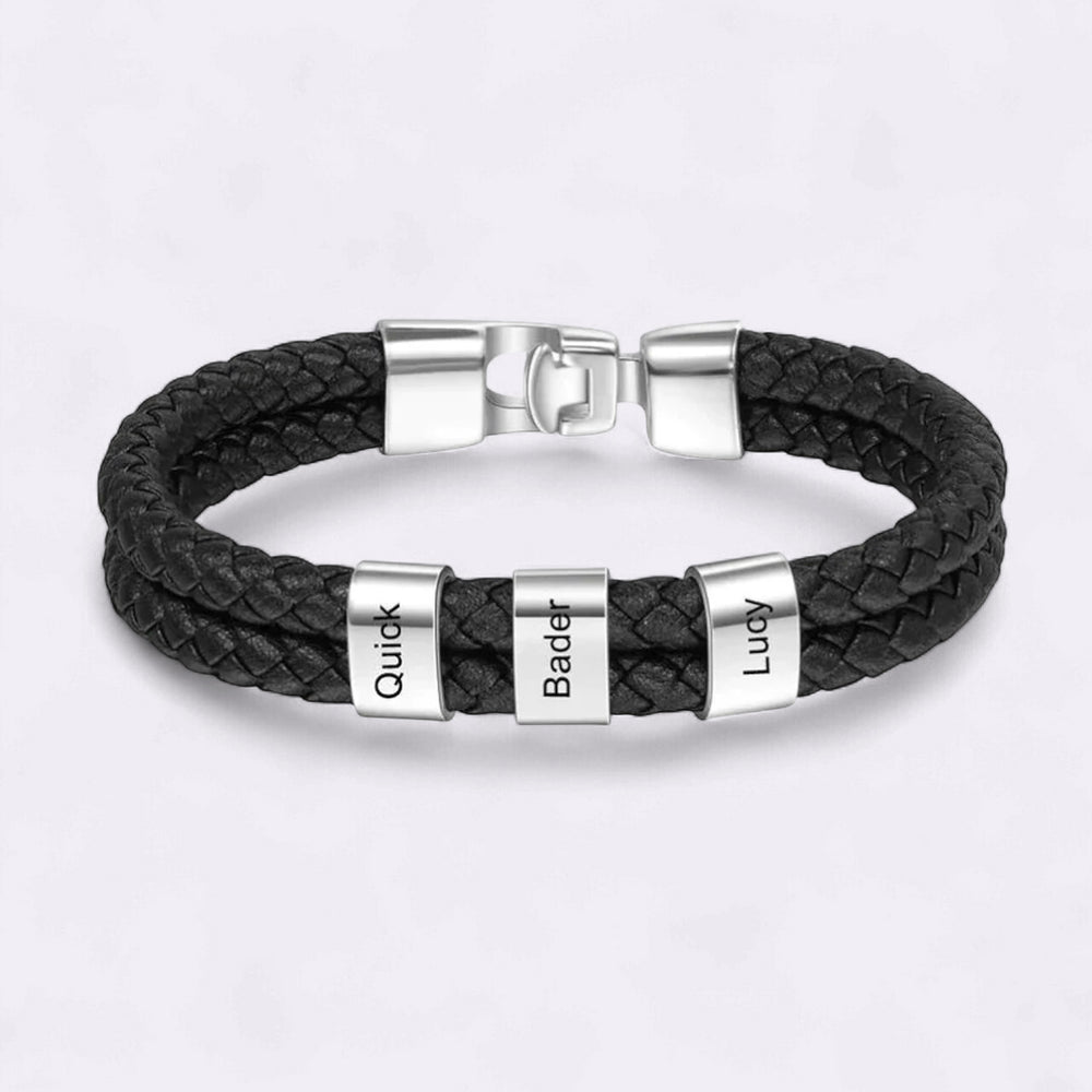 Black braided leather bracelet with silver name tags on a light gray background