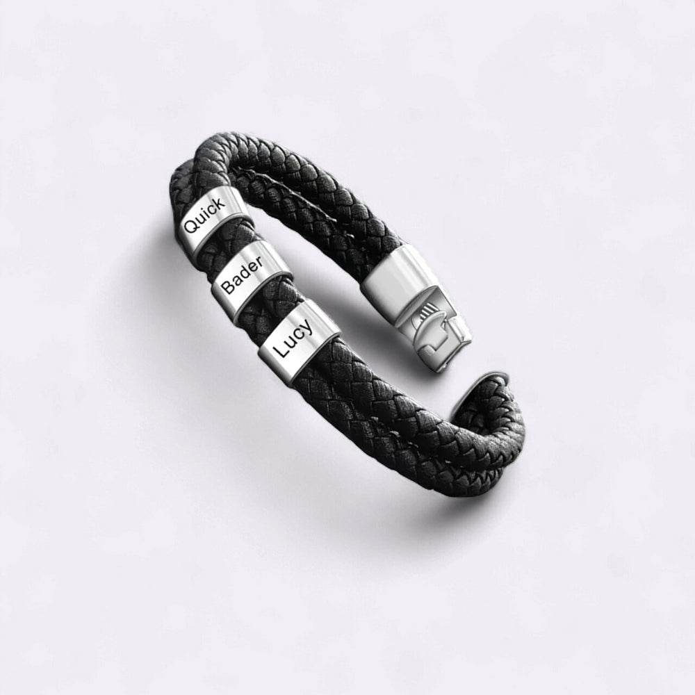 Black braided leather bracelet with silver accents on a light gray background