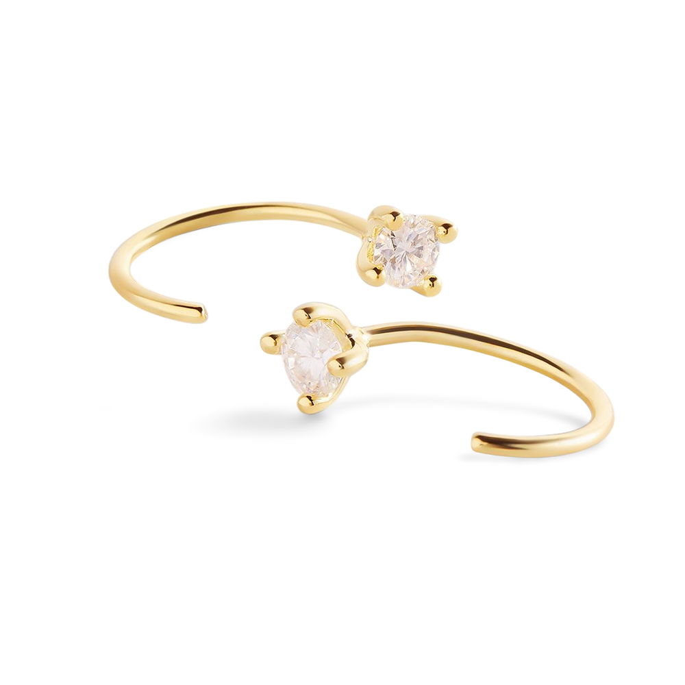 A pair of gold-colored threader hoop earrings with round cut moissanite stones set with a 4-prong setting, displayed against a black background.