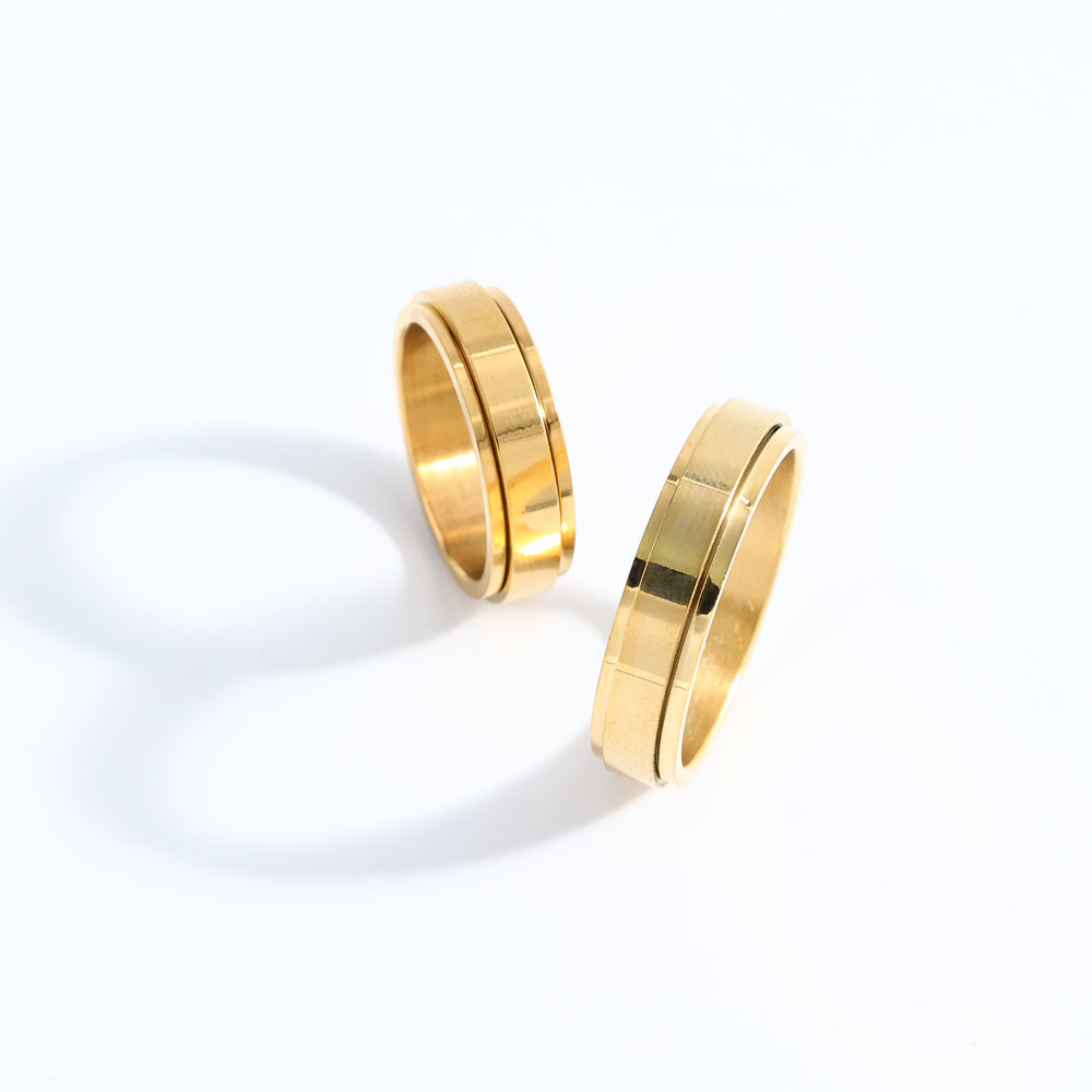 Two gold rings on a white background