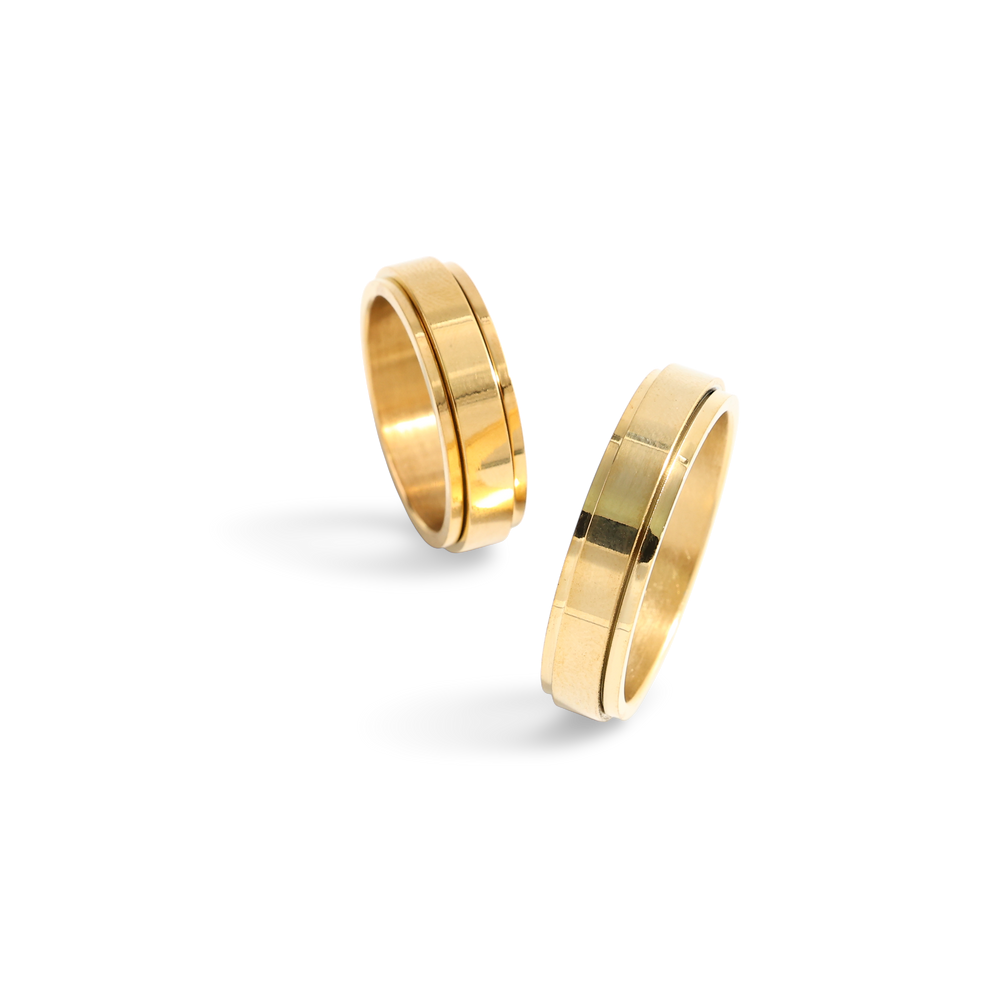 Two gold rings on a white background