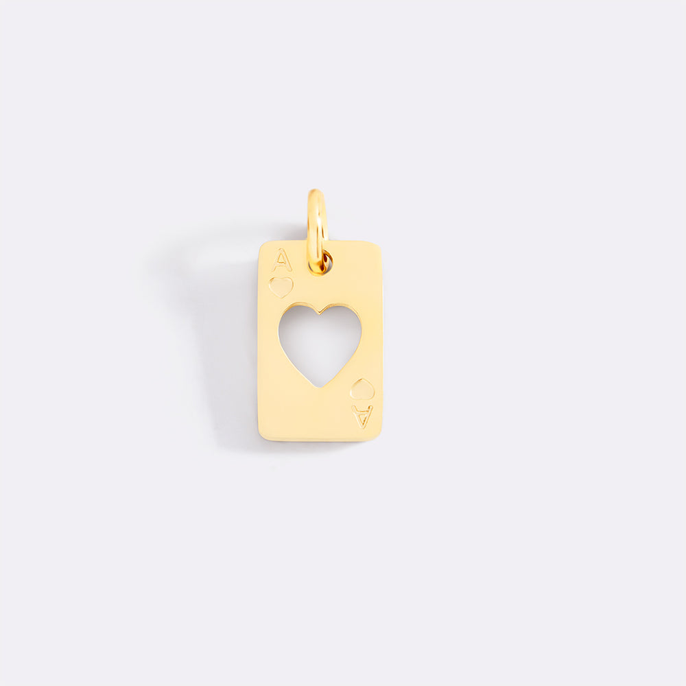 Gold pendant with a heart cutout on a light gray background