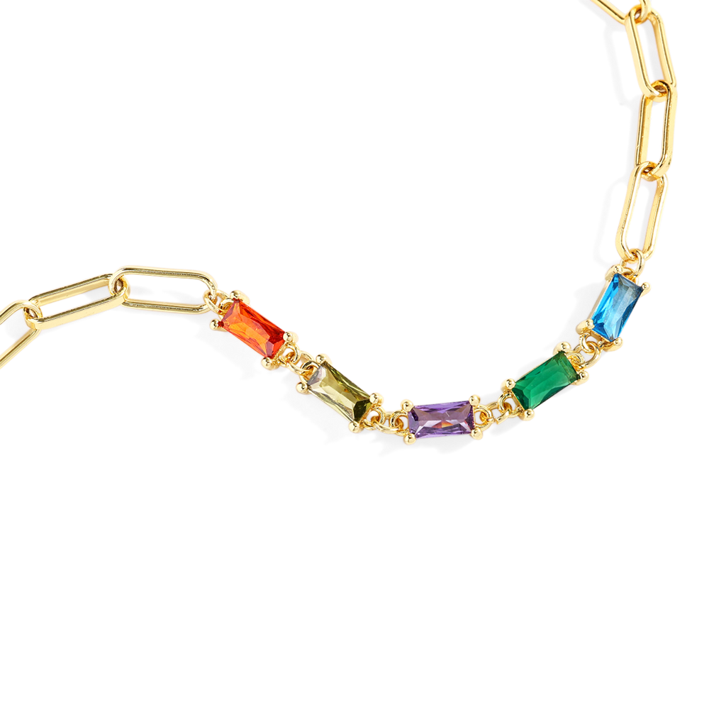 Gold bracelet with colorful gemstones on a white background