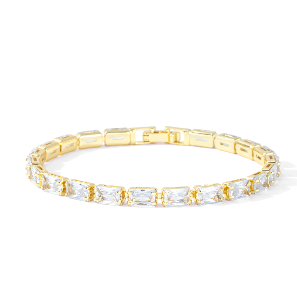 Gold baguette tennis bracelet with cubic zirconia stones on a white background