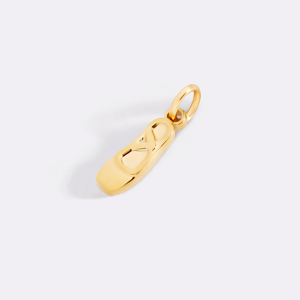 Gold pendant on a light gray background