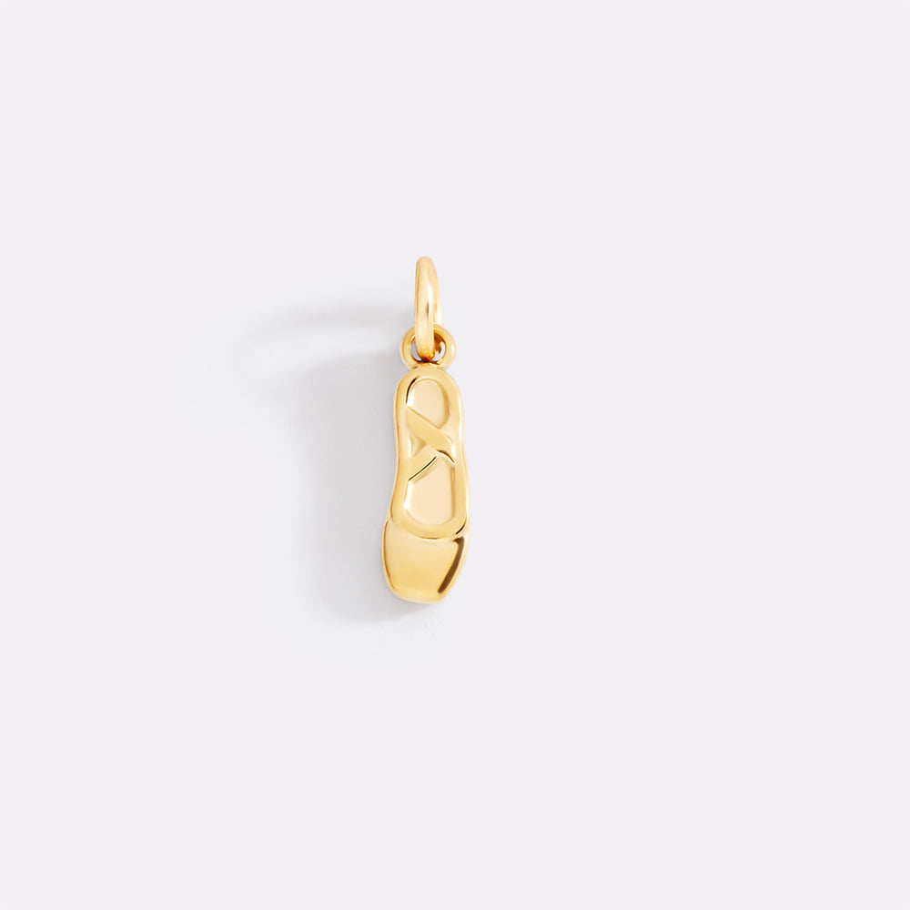 Gold shoe charm on a white background