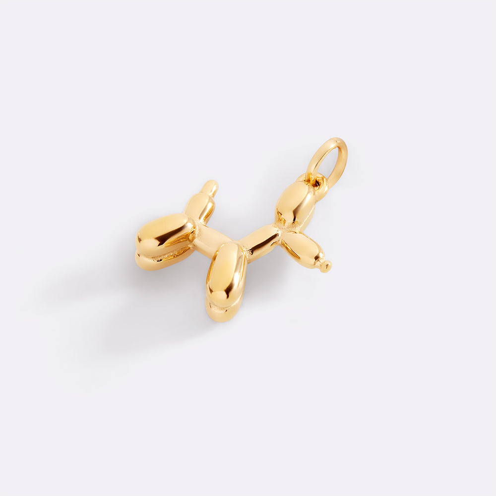 Gold balloon dog charm on a white background