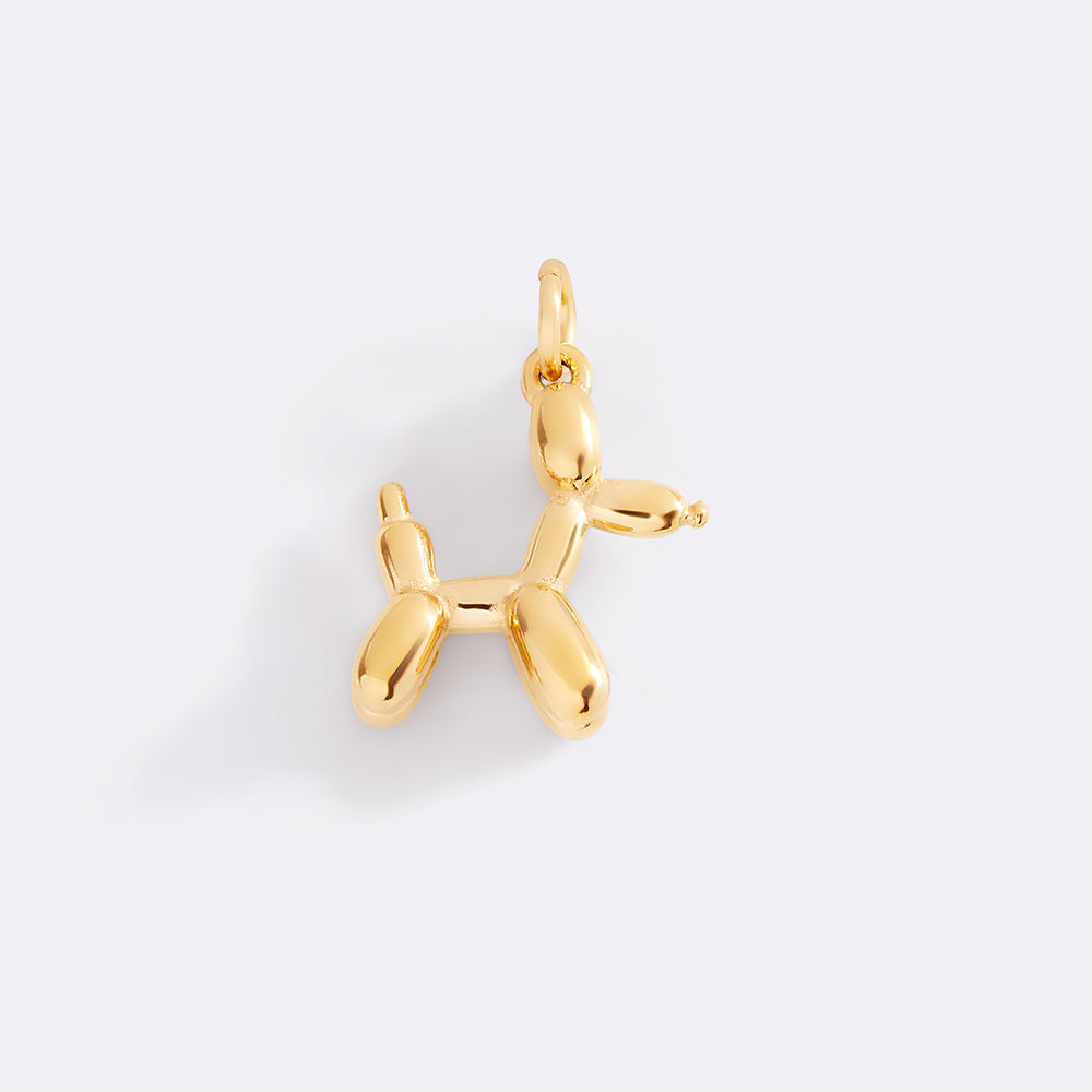 Gold balloon dog pendant on a white background