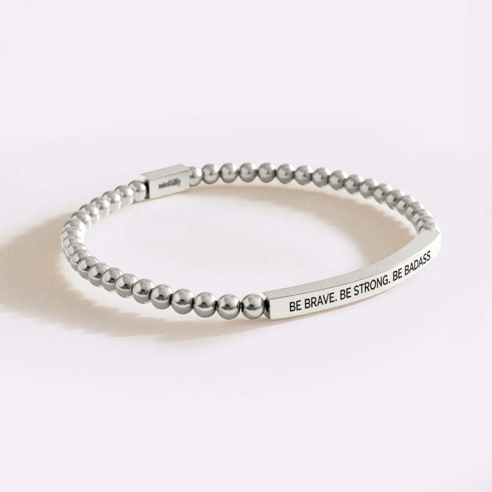 Silver beaded bracelet with motivational quote on a white background