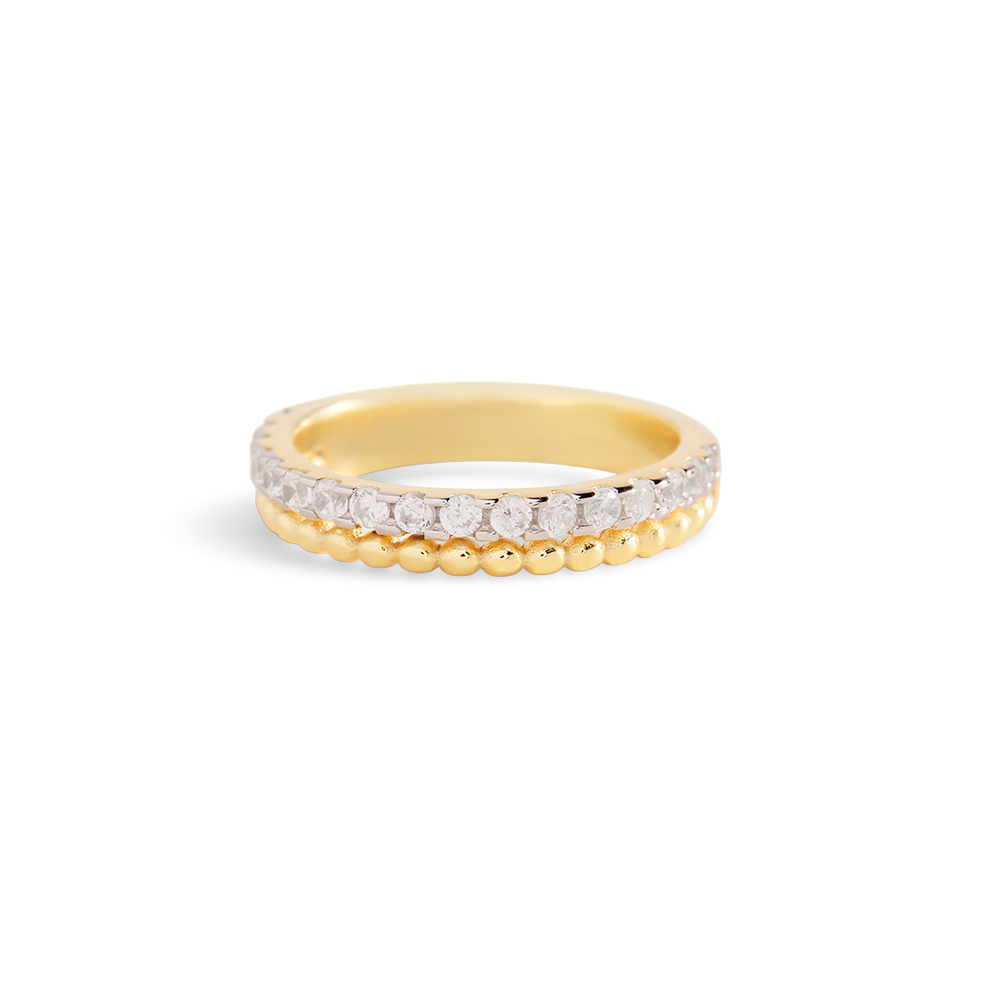 Gold ring with embedded diamonds on a light gray background