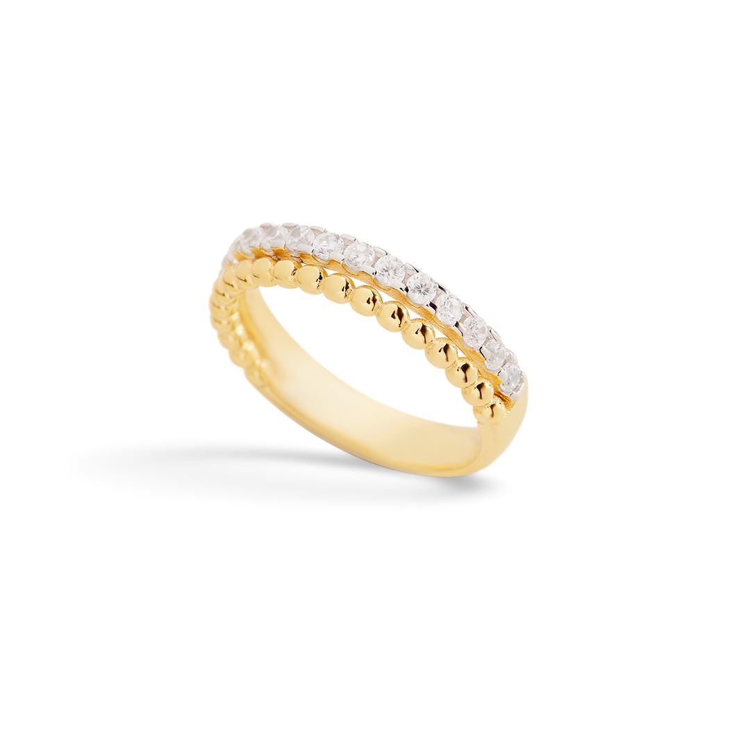 Gold ring with embedded diamonds on a light gray background