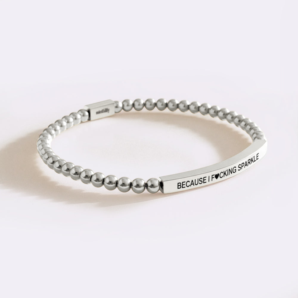 Silver beaded bracelet with engraved text on a white background