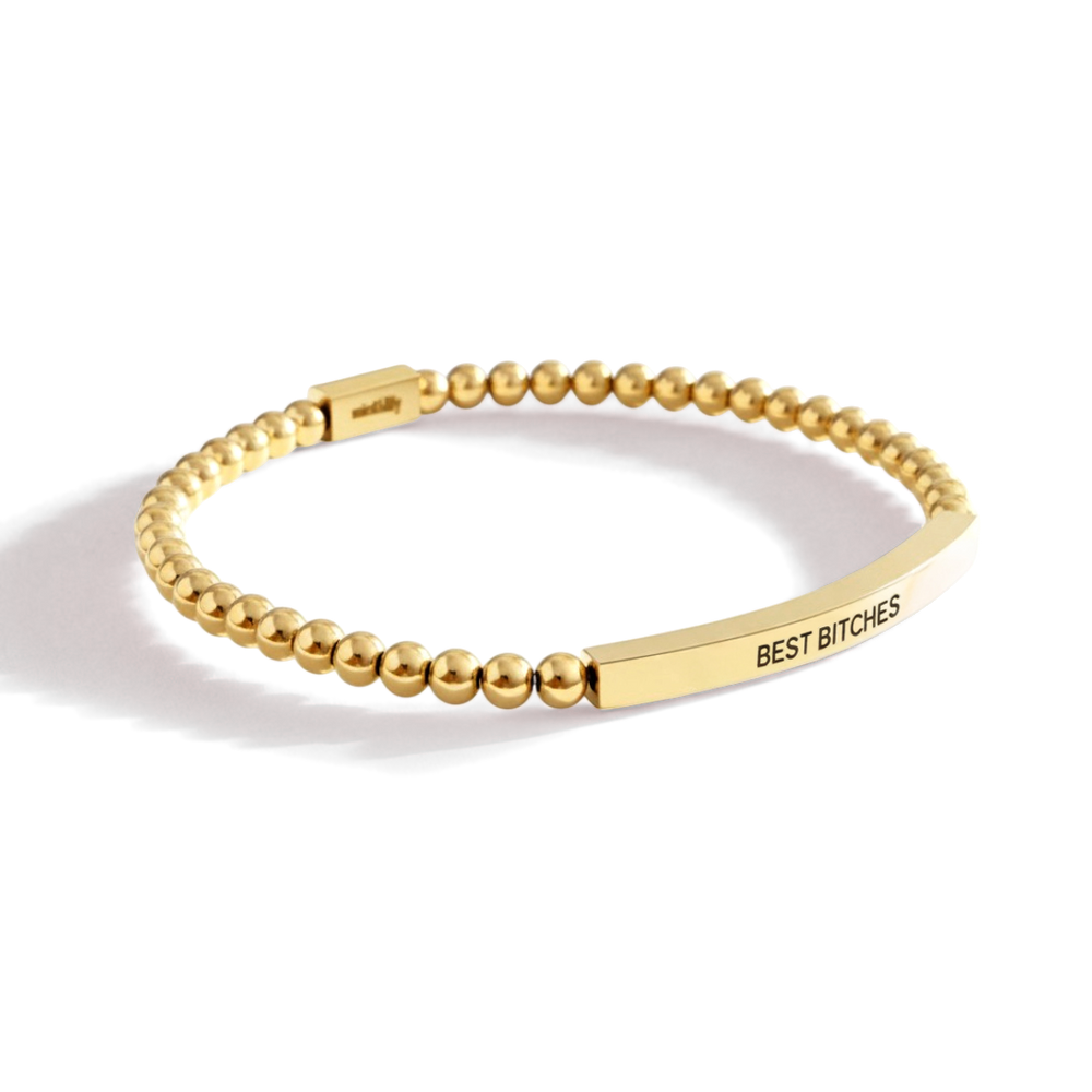 Gold beaded bracelet with 'BEST BITCHES' engraving on a white background