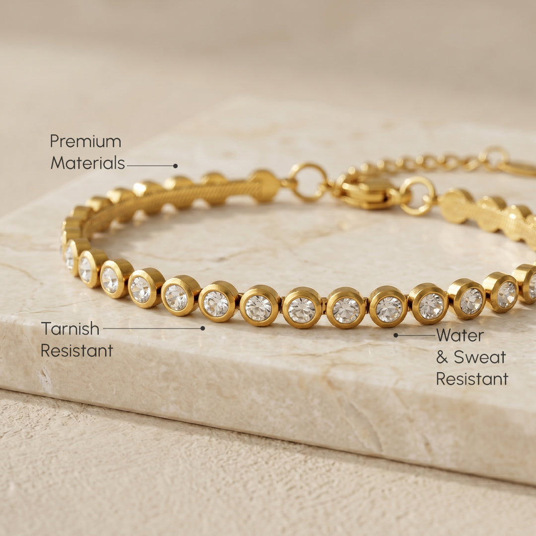 Gold bracelet with diamond-like beads on a brown background