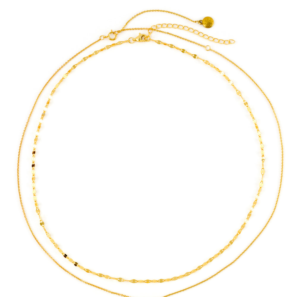 Classic Bezel Necklace and Petal Chain in 18k gold over sterling silver, laid flat together in a loose circle on a white background.