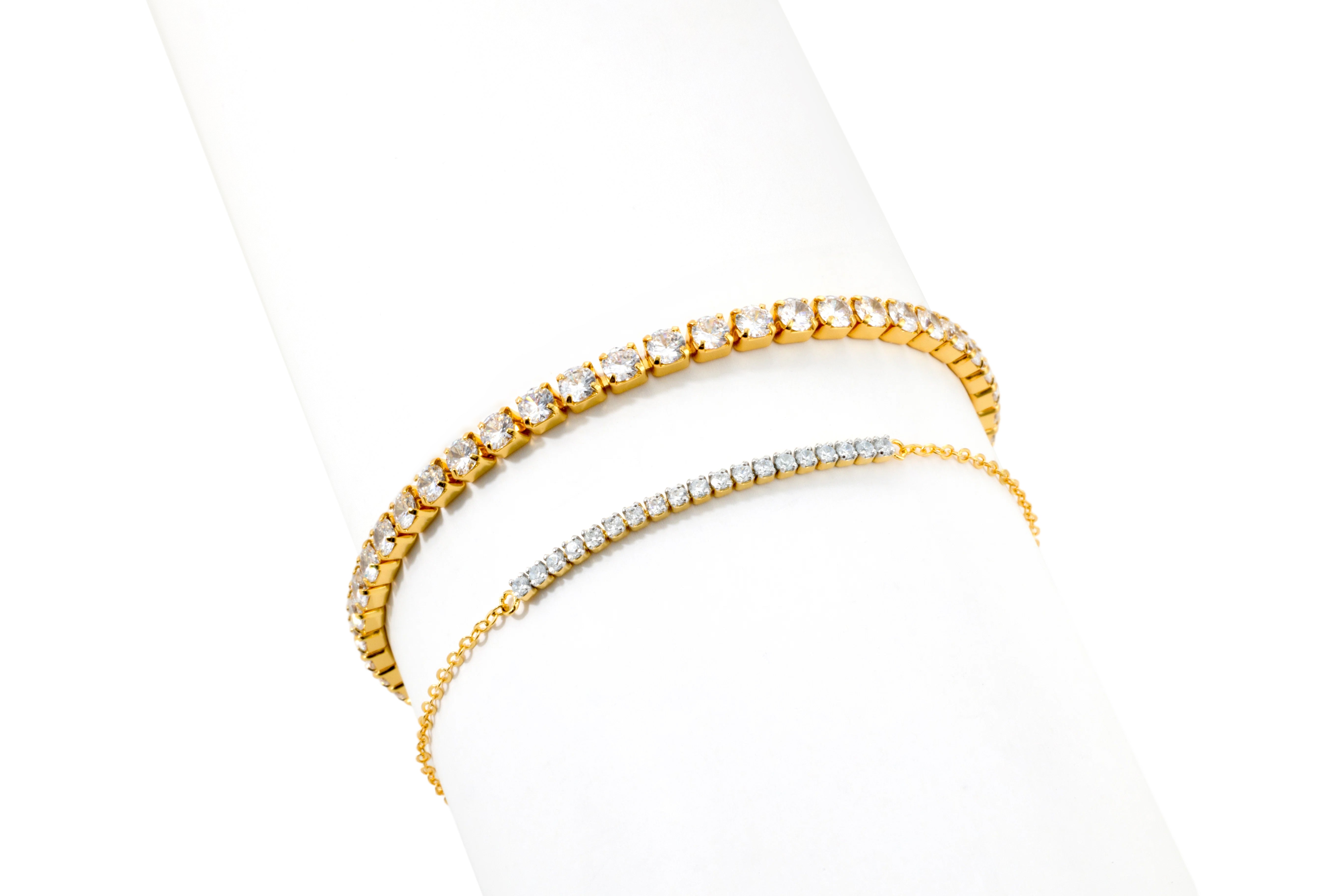 18k gold plated Classic Tennis Bracelet and Petite Line Bracelet stack on a white background.