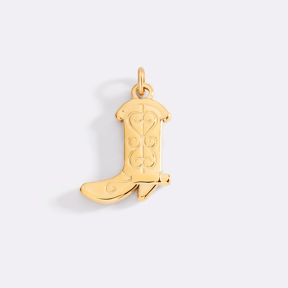 Gold cowboy boot pendant on a light gray background