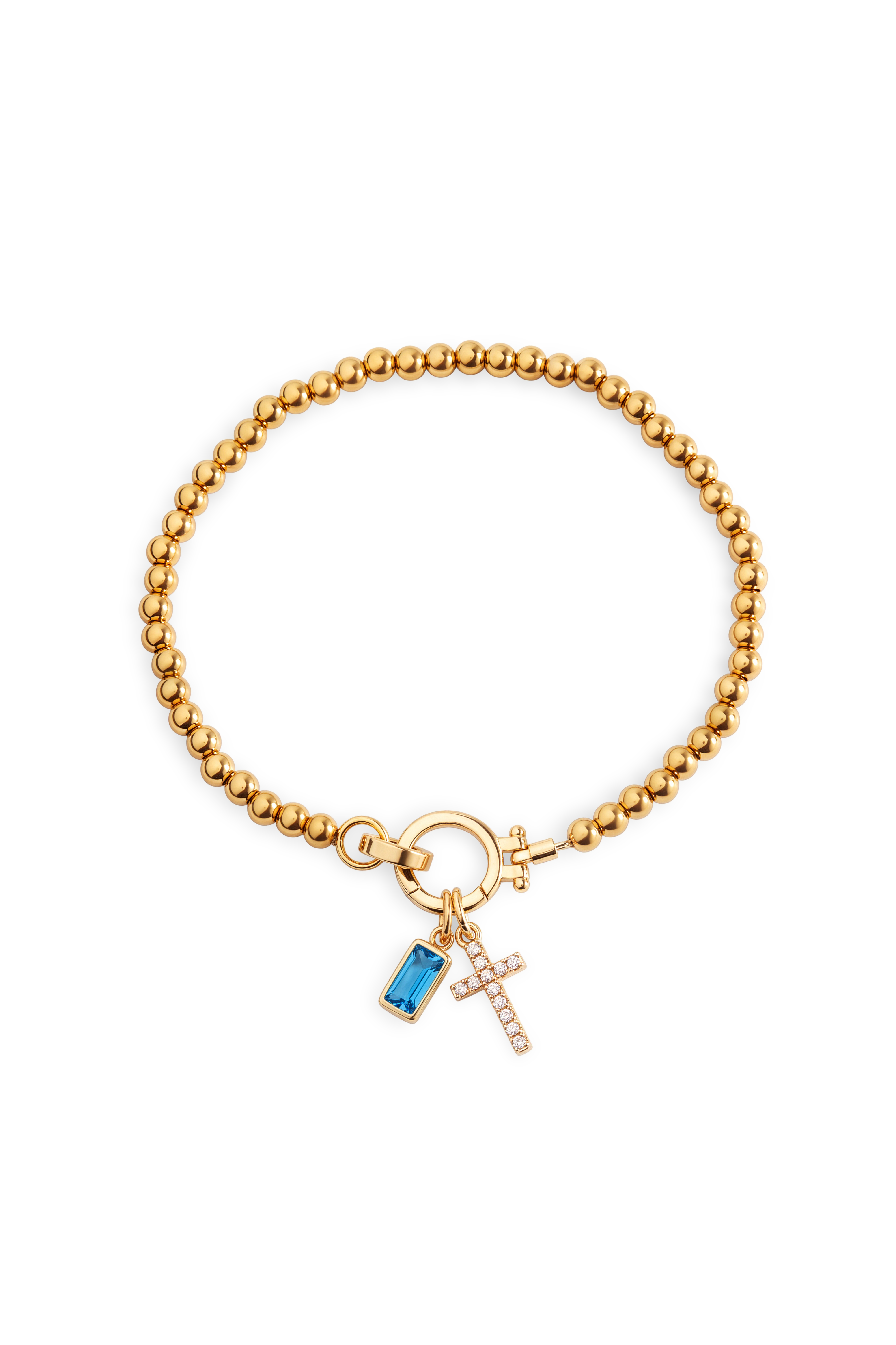 Cross Charm Birthstone Bracelet with gold beaded chain, cross charm and December blue topaz birthstone charm on a white background.