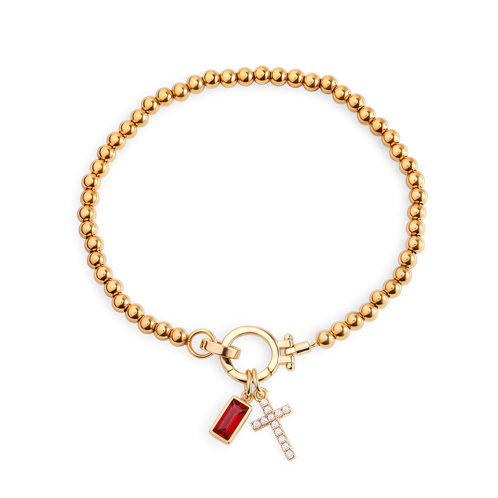 Cross Charm Birthstone Bracelet with gold beaded chain, cross charm and January garnet birthstone charm on a white background.
