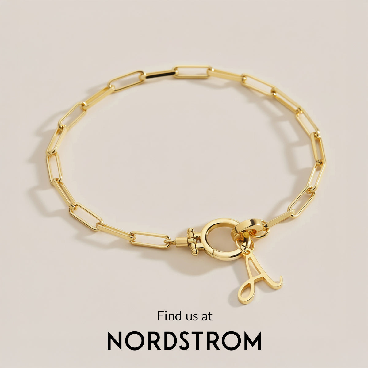 Gold bracelet with a clasp on a beige background, Nordstrom branding visible.