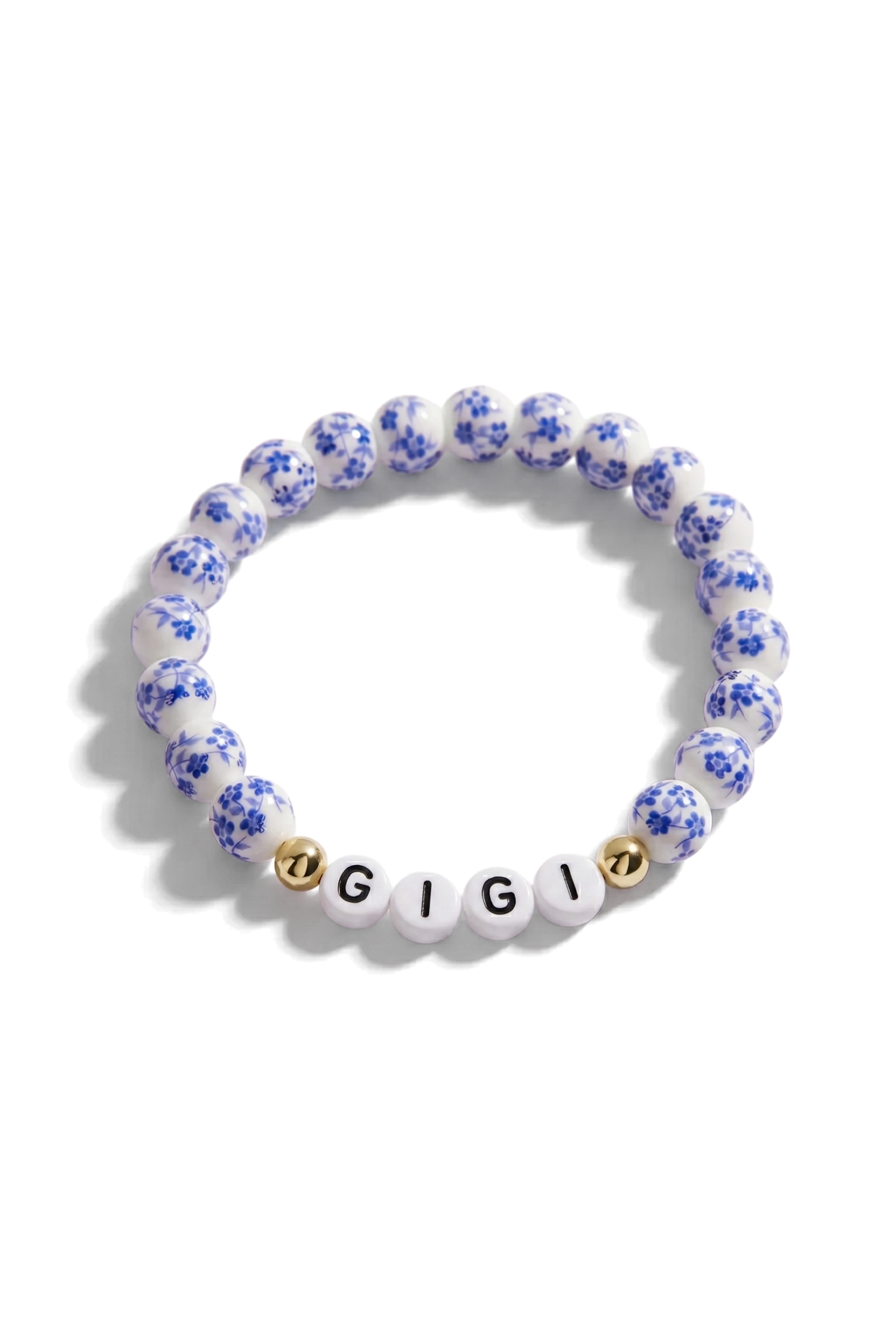Bracelet with blue floral beads and 'GIGI' beads on a white background