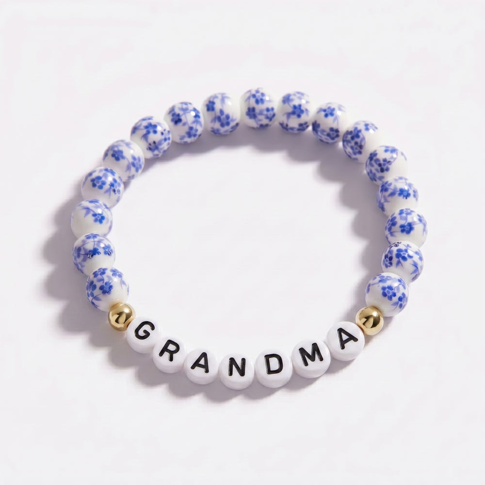 Bracelet with floral beads and 'GRANDMA' letters on a white background