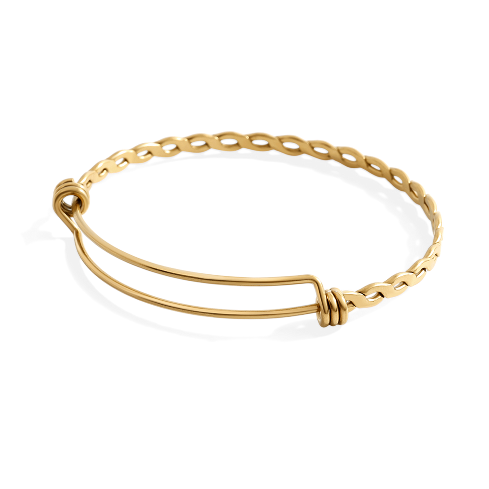 Gold bracelet on a light gray background