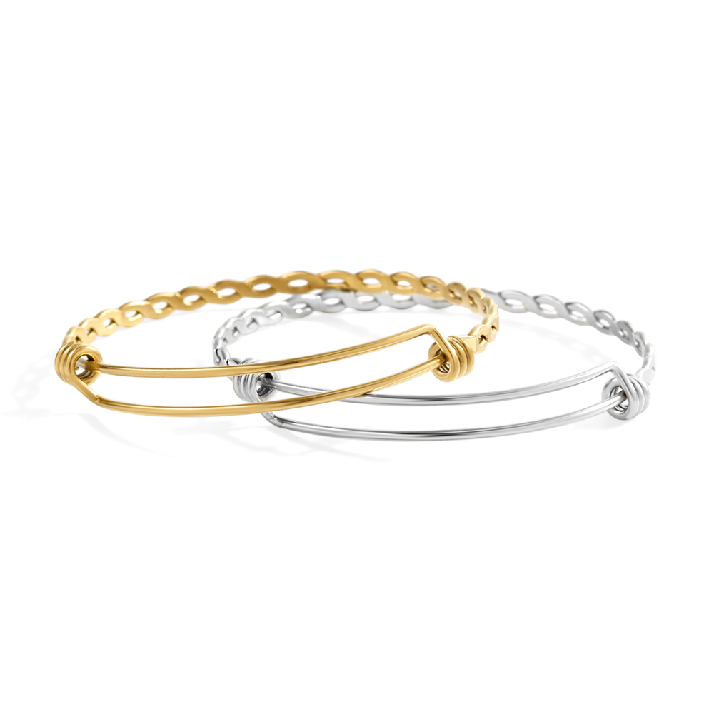 Gold and silver bangles on a light gray background