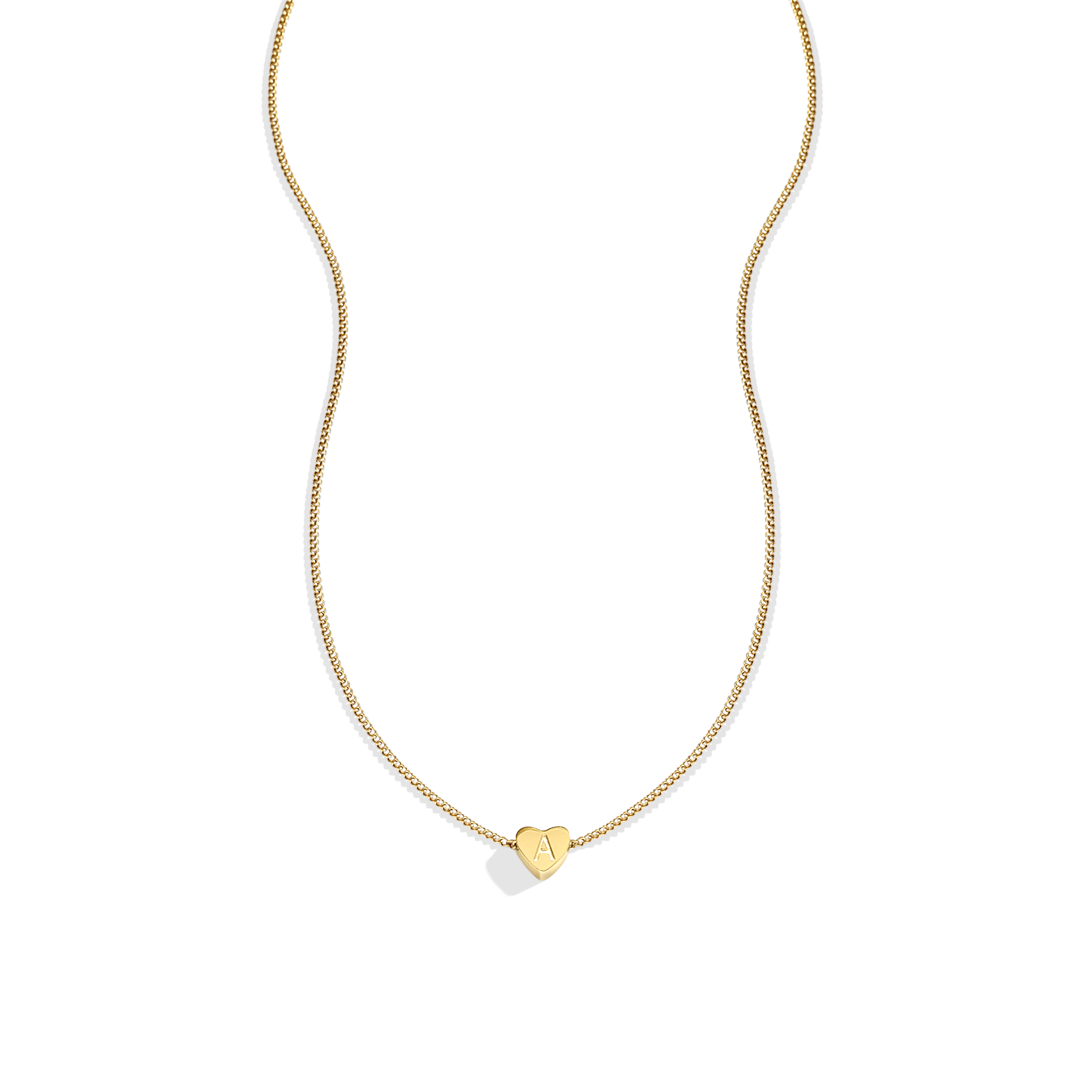Gold necklace with a heart-shaped pendant on a white background