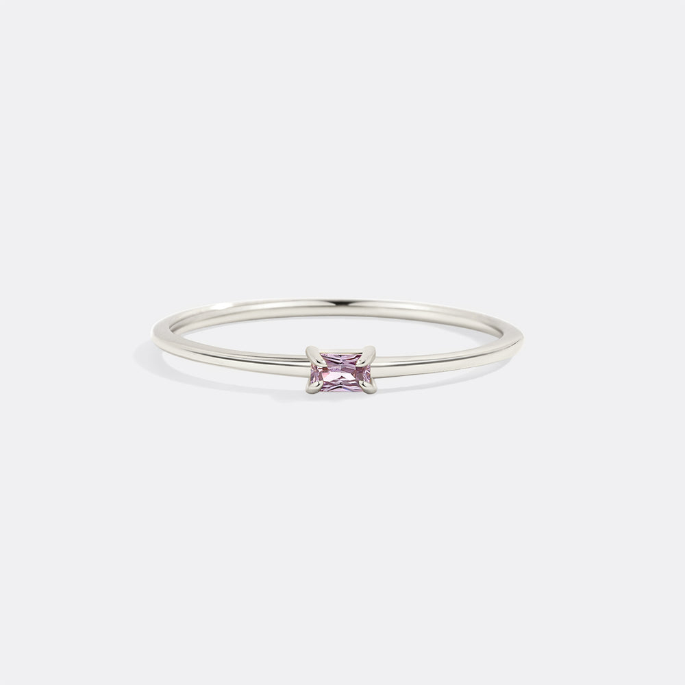 Silver ring with a pink gemstone on a white background