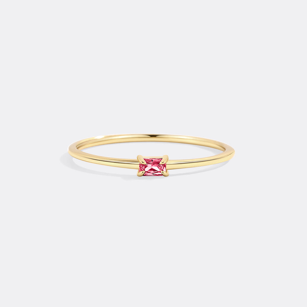 Gold ring with a pink gemstone on a white background