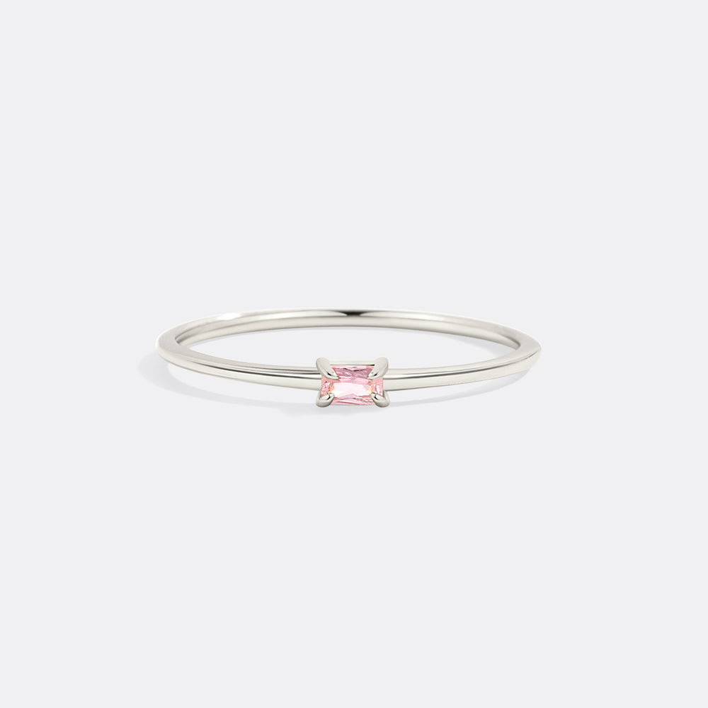 Silver ring with a pink gemstone on a white background