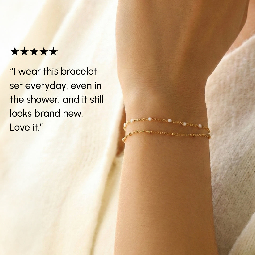 Gold bracelet on a wrist with a five-star rating and customer review text.
