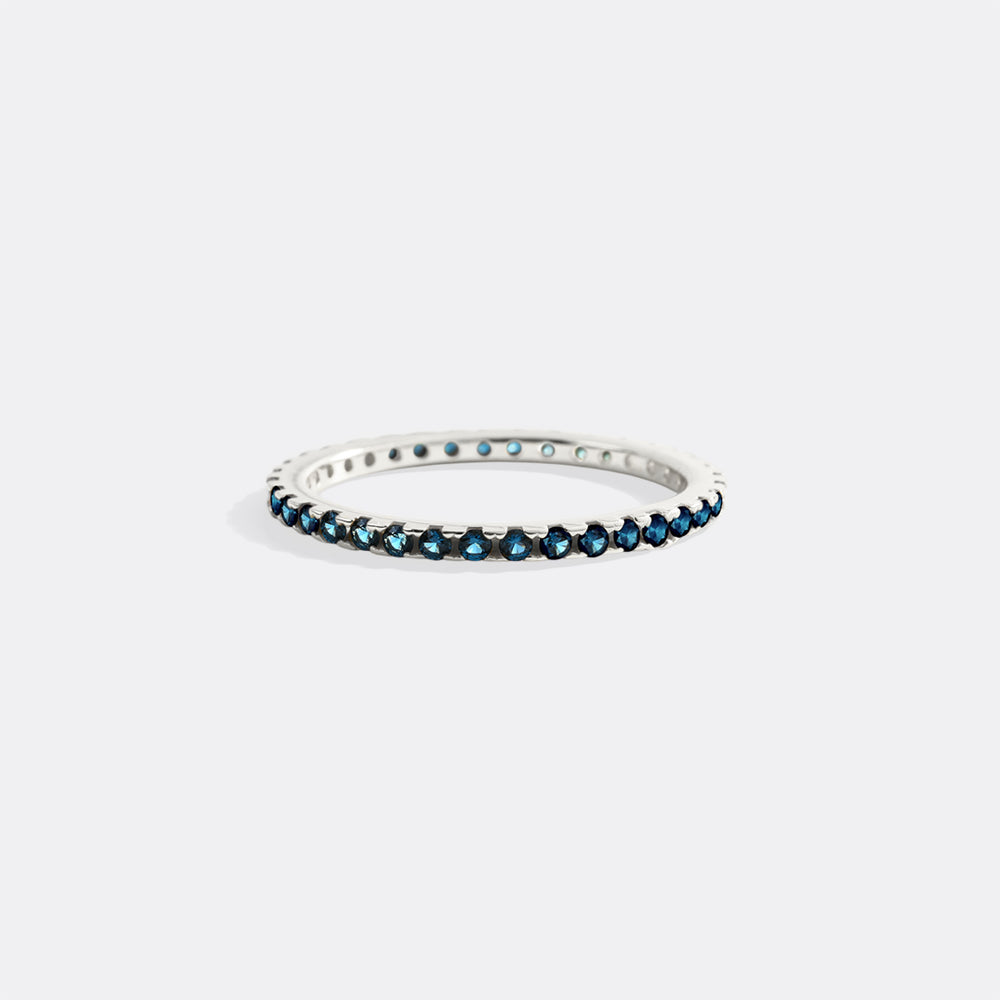 Silver ring with blue gemstones on a white background