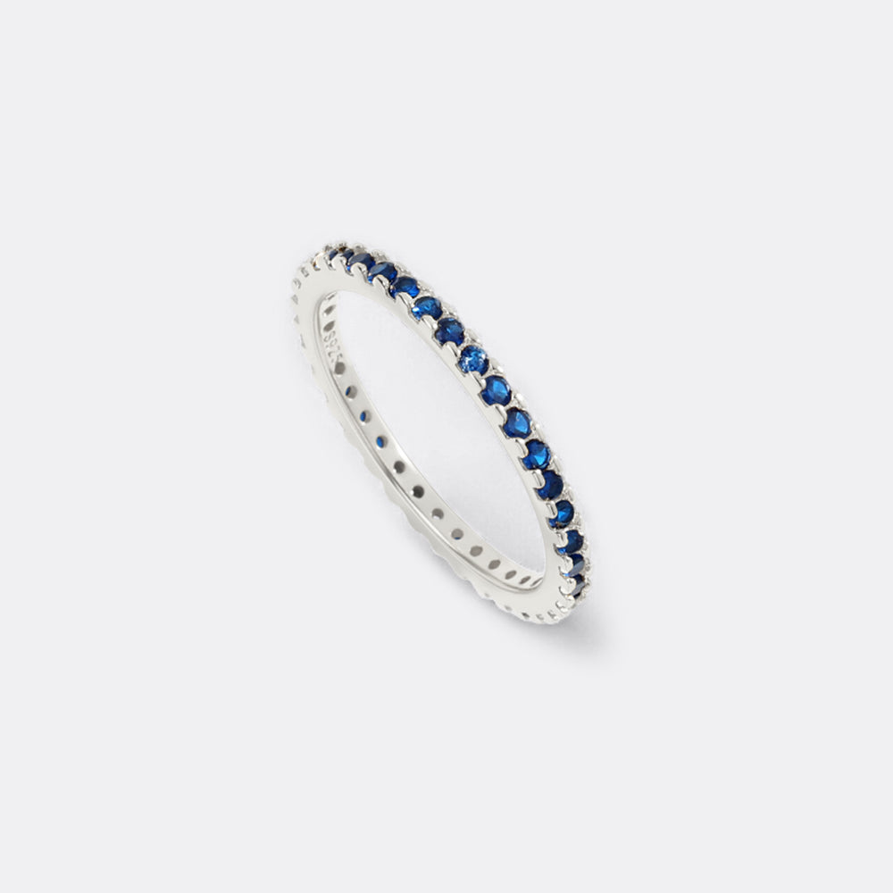 Silver ring with blue stones on a white background