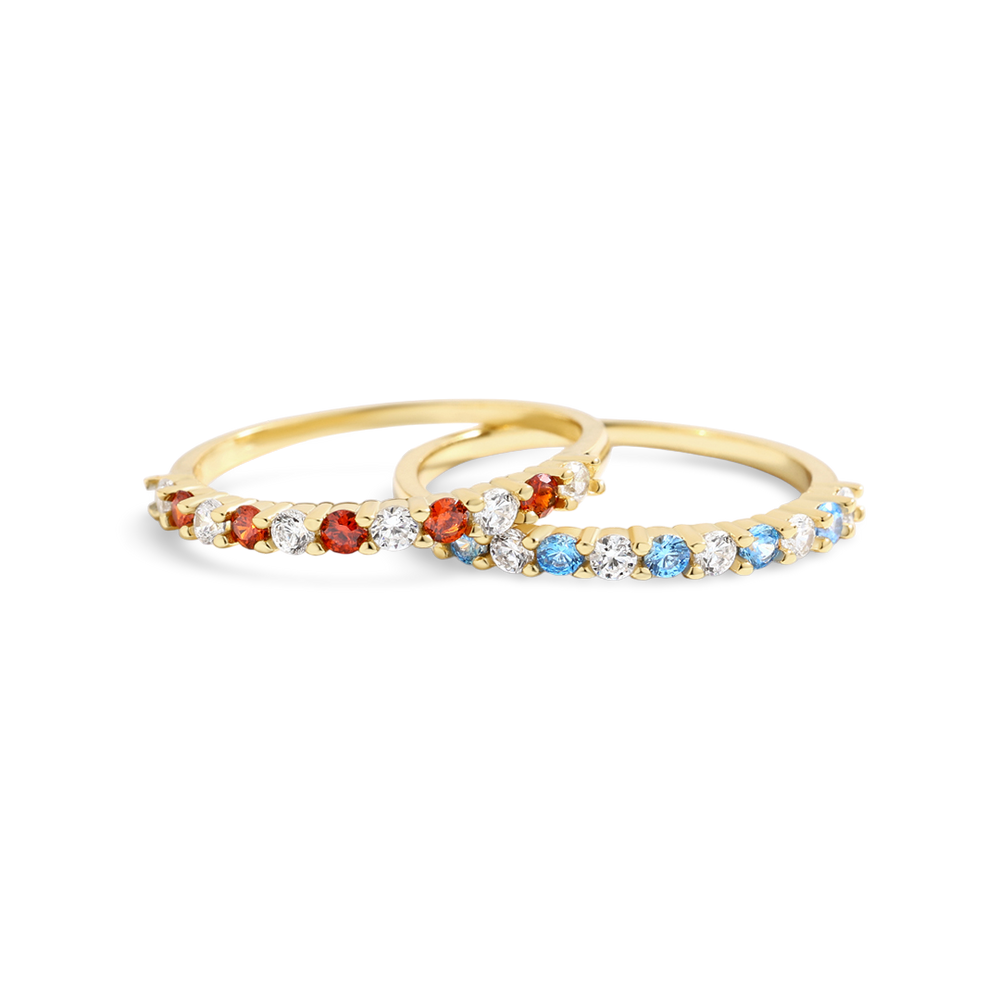 Gold ring with colorful gemstones on a white background