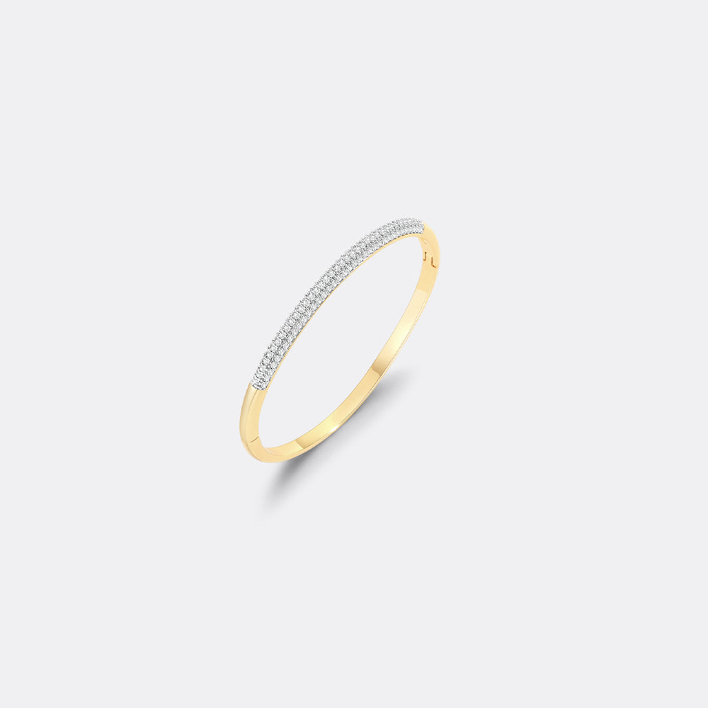 Gold ring with embedded diamonds on a light gray background