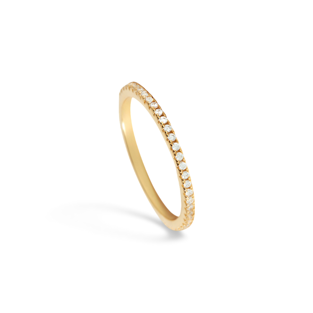 Gold ring with small diamonds on a light gray background