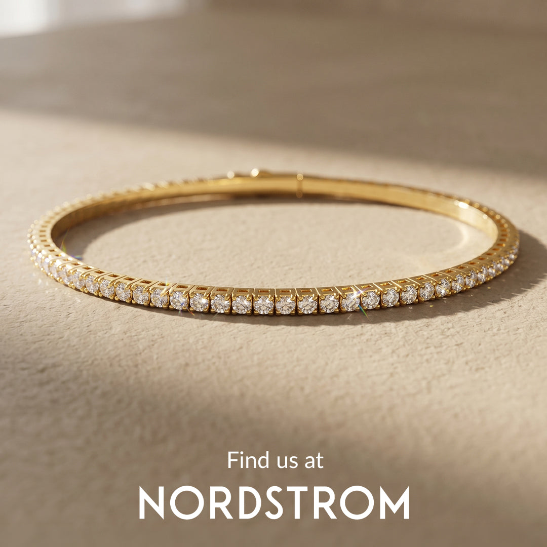 Gold bracelet with diamonds on a beige surface, Nordstrom branding visible.