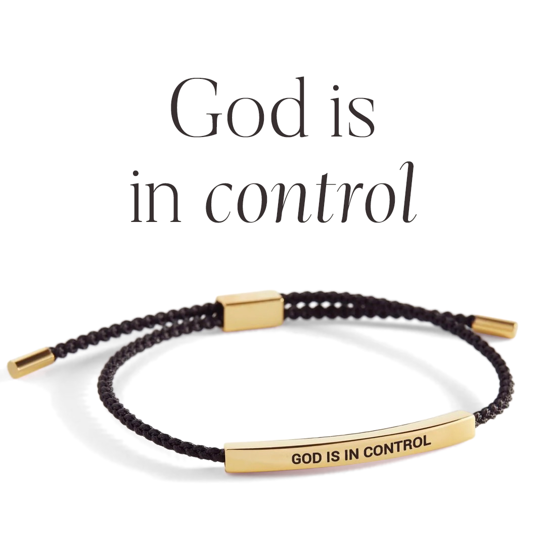 Bracelet with 'GOD IS IN CONTROL' tag on a light background