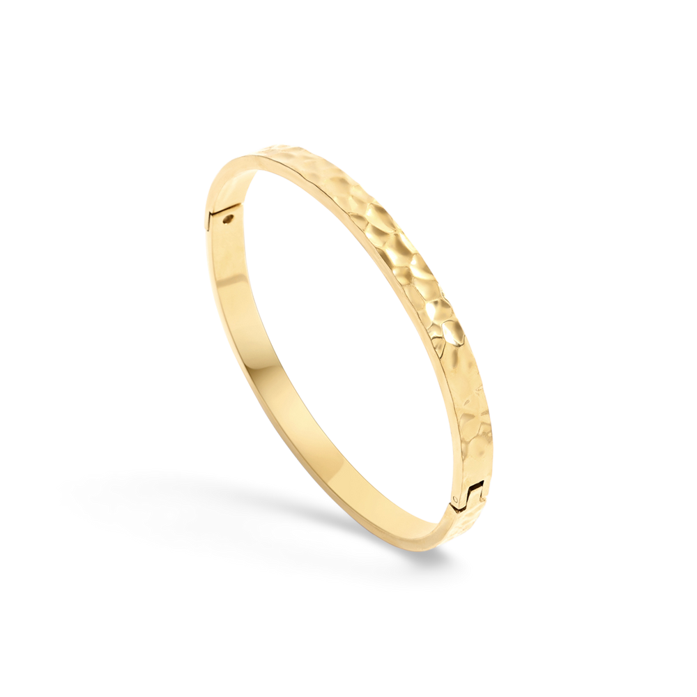Gold bracelet on a light gray background