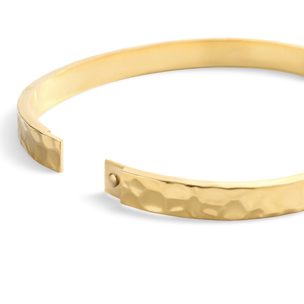 Gold bangle on a white background