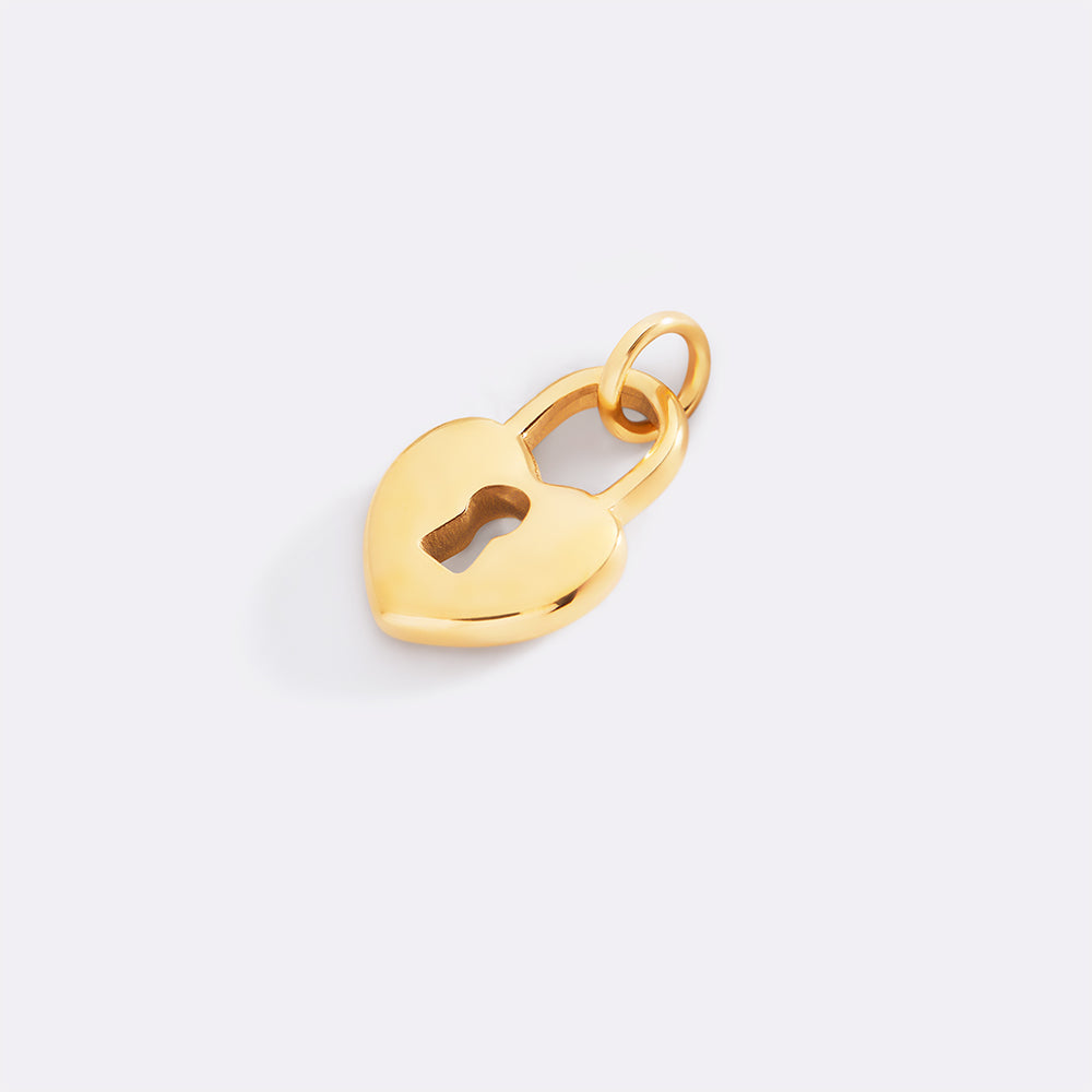 Gold heart-shaped keyhole pendant on a light gray background
