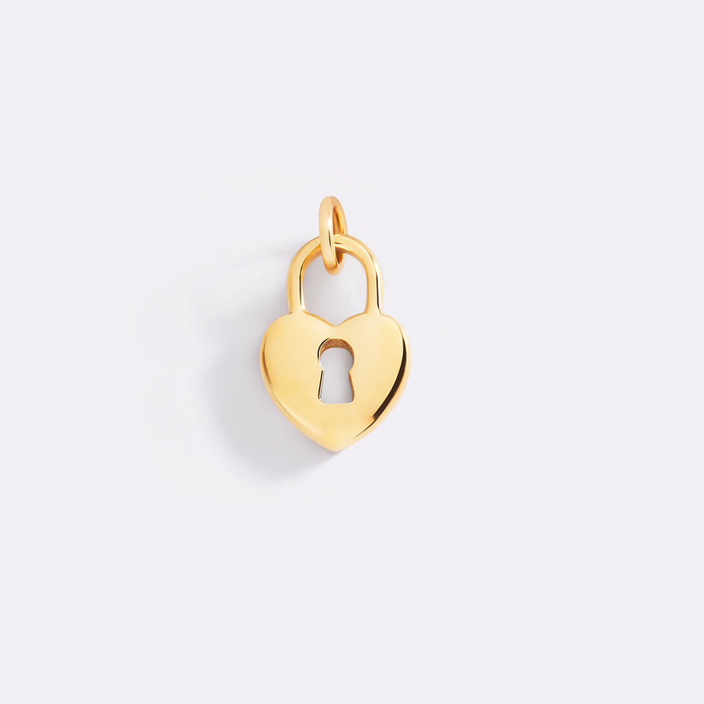 Gold heart-shaped padlock charm on a light gray background