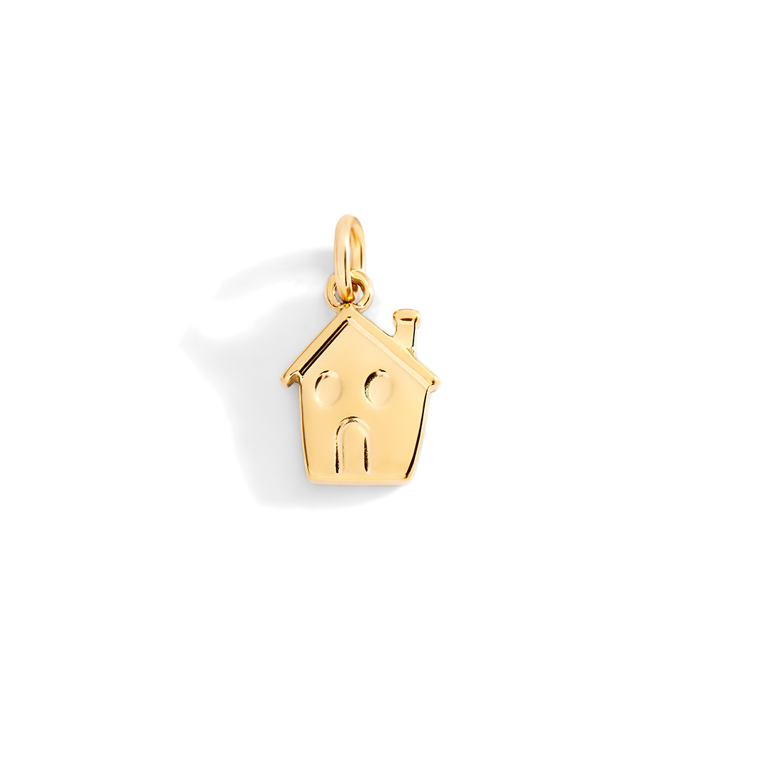 Gold house-shaped pendant with a family design on a light gray background