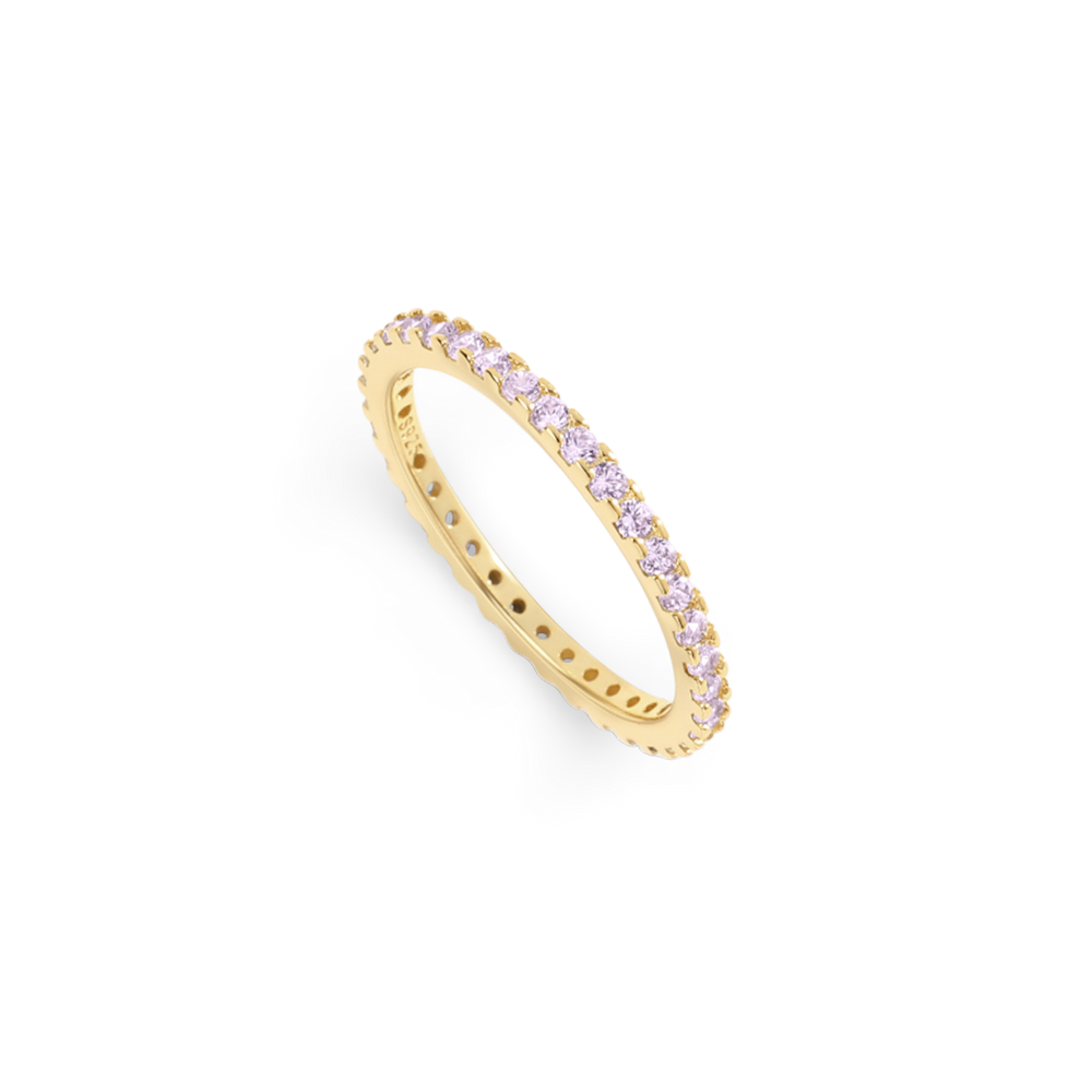 Gold ring with pink gemstones on a light gray background