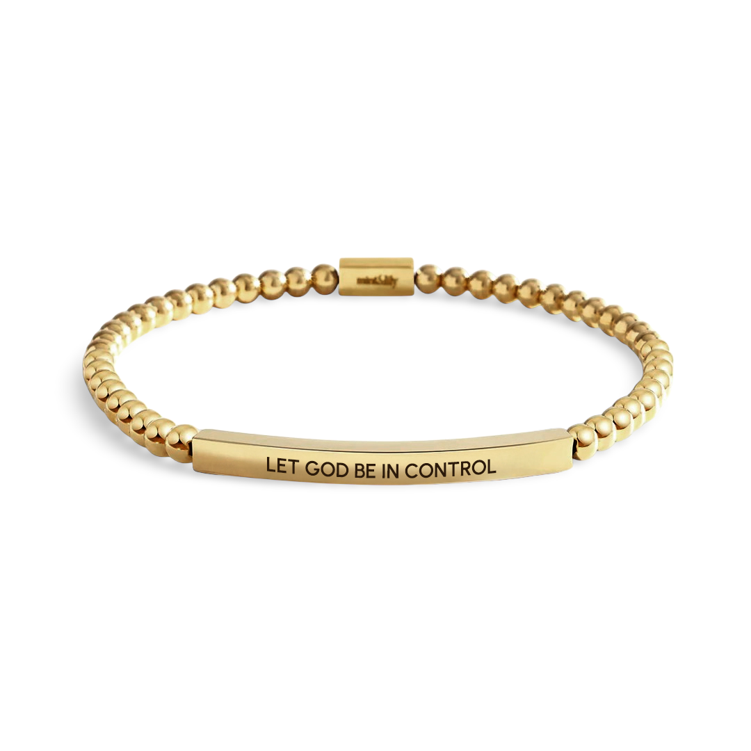 Gold bracelet with 'LET GOD BE IN CONTROL' engraving on a light background