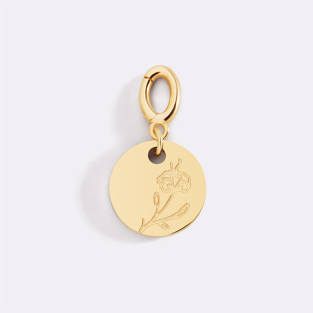 Gold pendant with floral design on a light gray background